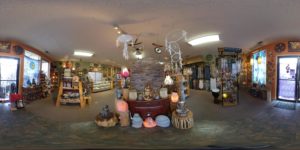 Wide angle view of the interior of the store with crystals, candles, and decor items