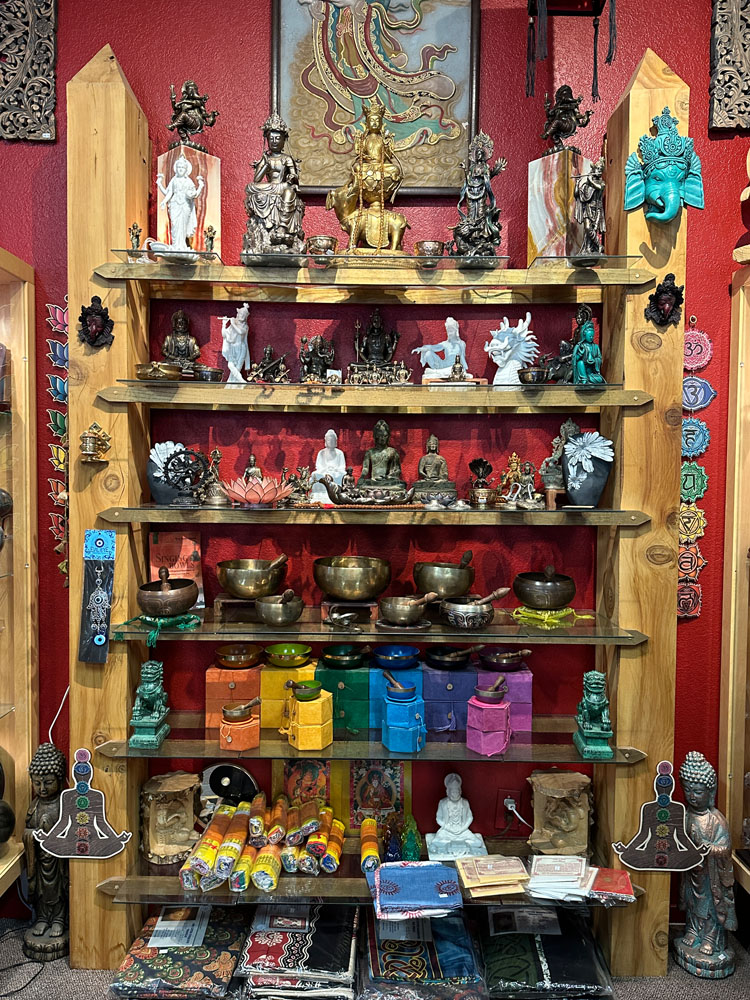 Display of figurines, sound bowls, and cloths.