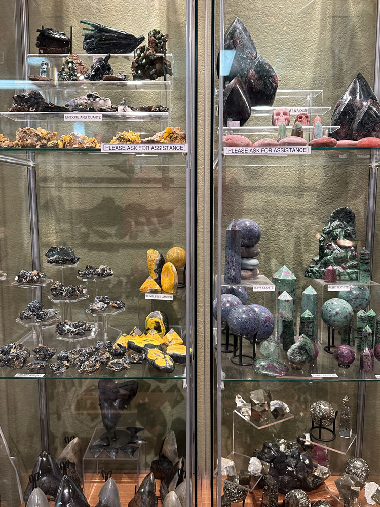 Various crystals in display case - flames, spheres, rocks, and more