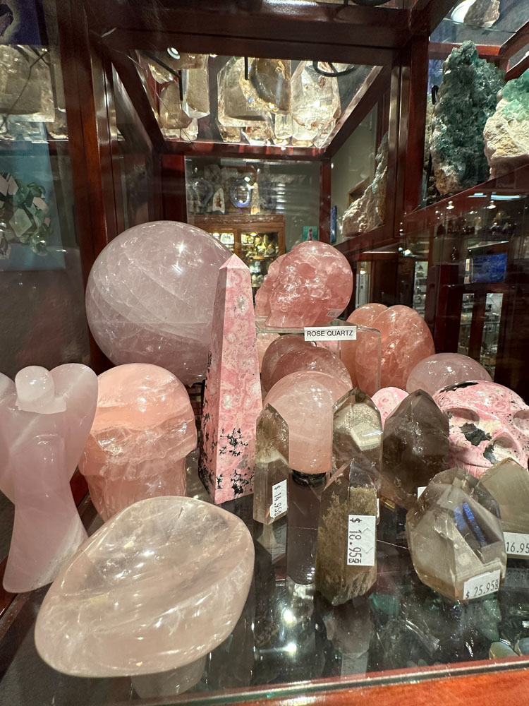 Rose quartz and other pink crystals in display case